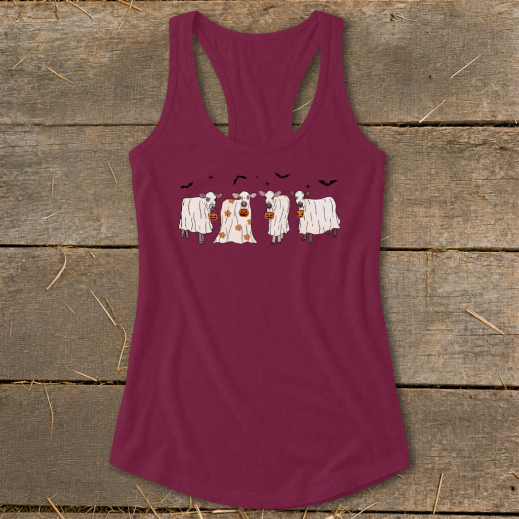Four cows in ghost costumes with pumpkins are on a maroon tank top.