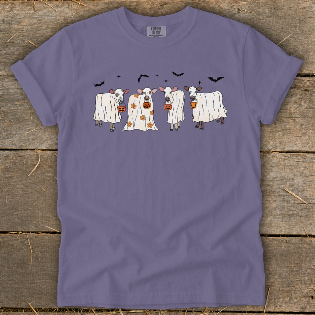 Ghost cows holding jack-o'-lanterns with bats above.