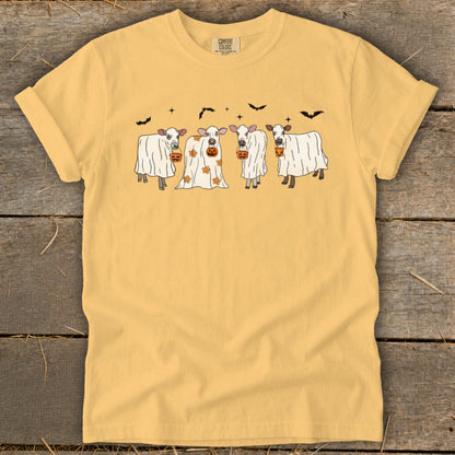 Yellow t-shirt with four cows dressed as ghosts holding pumpkin buckets.