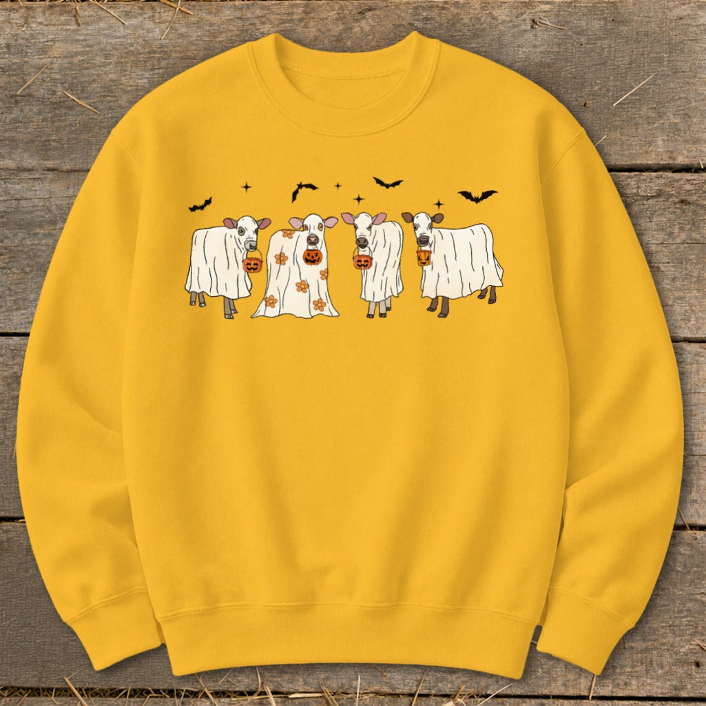 Four cows in ghost costumes with pumpkin buckets, bats and stars design.