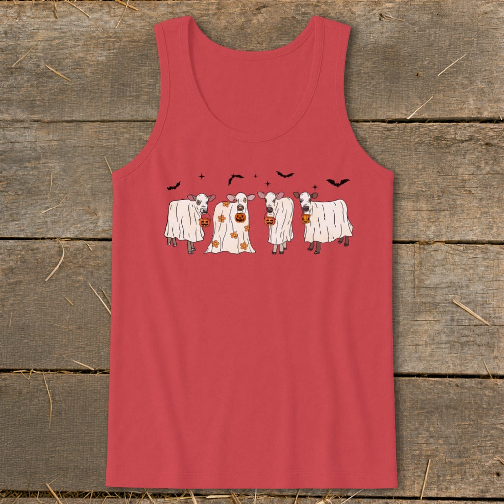 Four cows in ghost costumes hold jack-o'-lanterns with bats in the background.