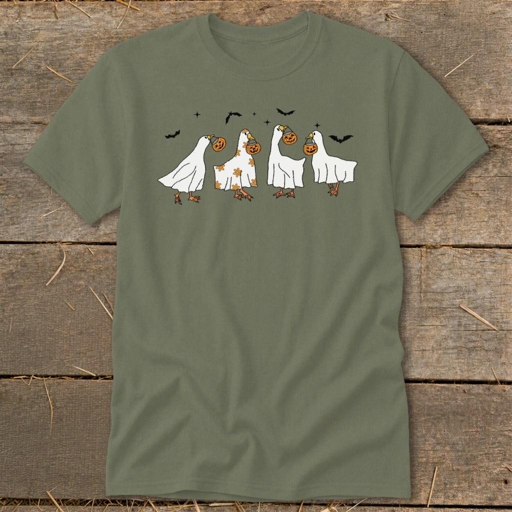 Four geese dressed as ghosts carry pumpkins, with bats in the sky.