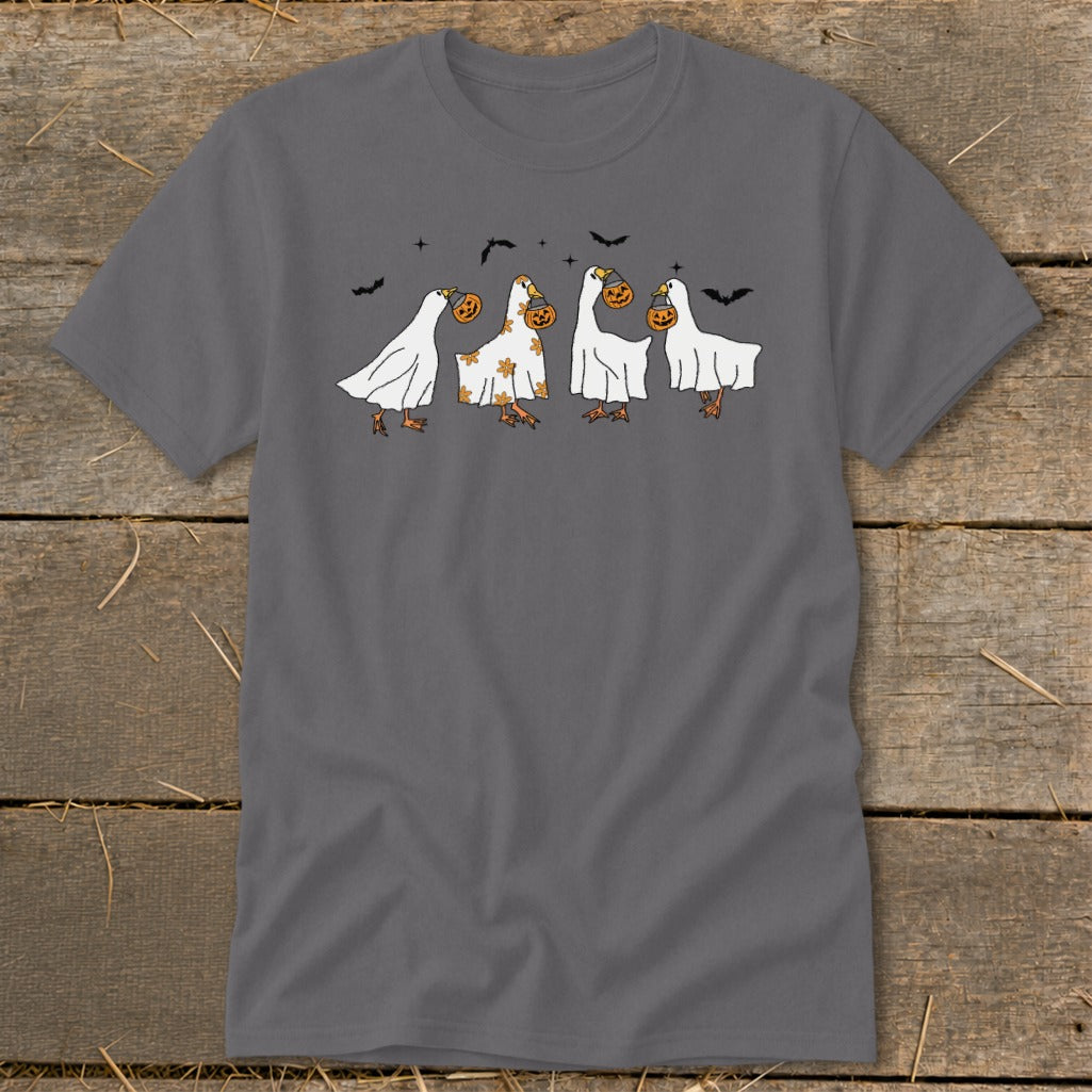 Four geese in ghost costumes carrying pumpkins, with bats in the background.
