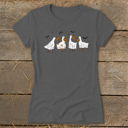 Four geese in ghost costumes holding jack-o'-lanterns with bats overhead.