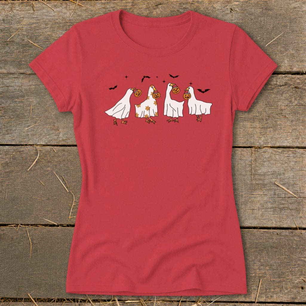T-shirt with cartoon ghosts trick-or-treating with pumpkins and bats.