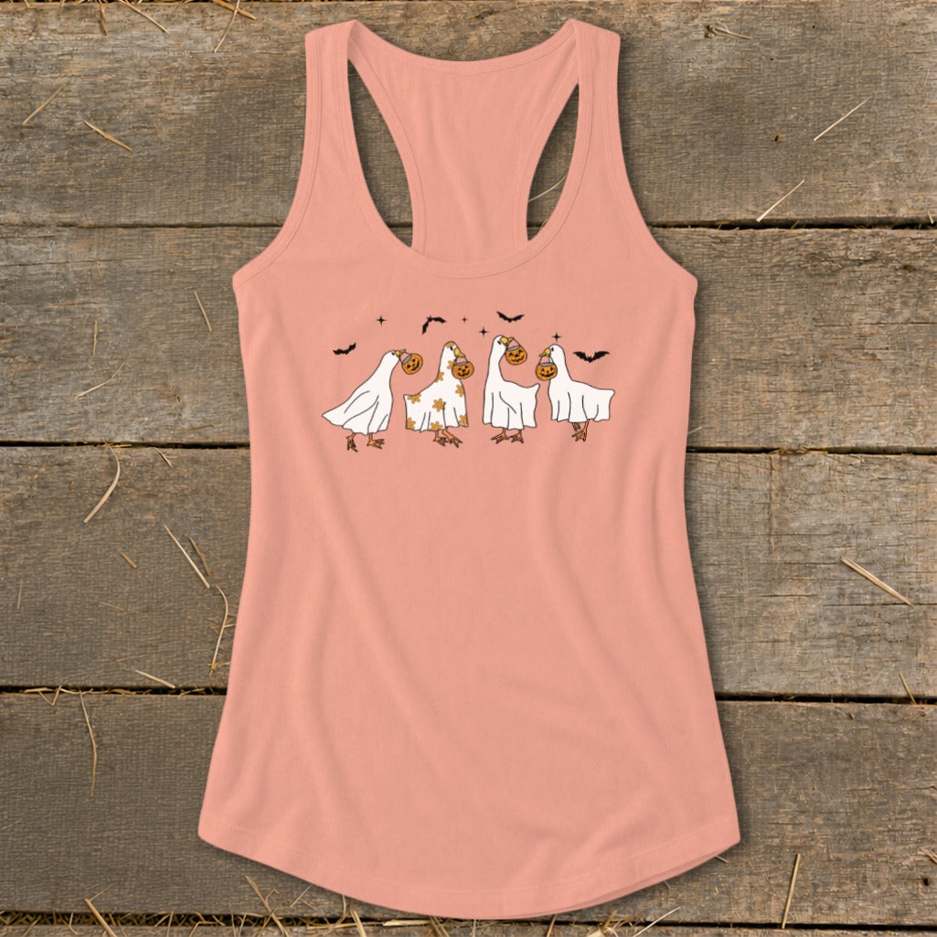 Peach tank top with a graphic of four birds dressed as ghosts carrying pumpkins.
