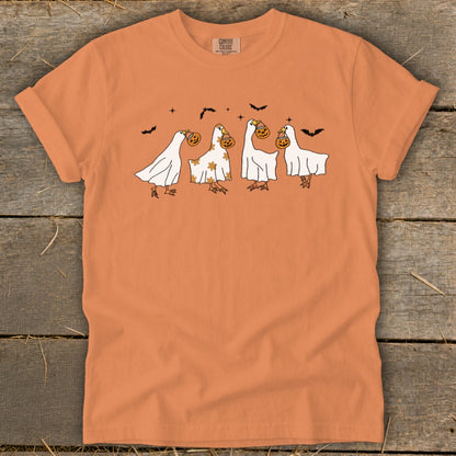 Orange t-shirt with four ghost-like ducks trick-or-treating and bats.