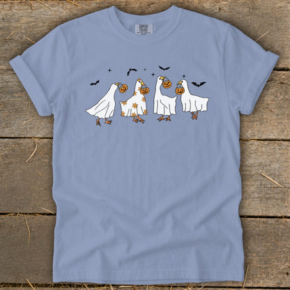 Ghosts with pumpkins on a light blue t-shirt with bats above.