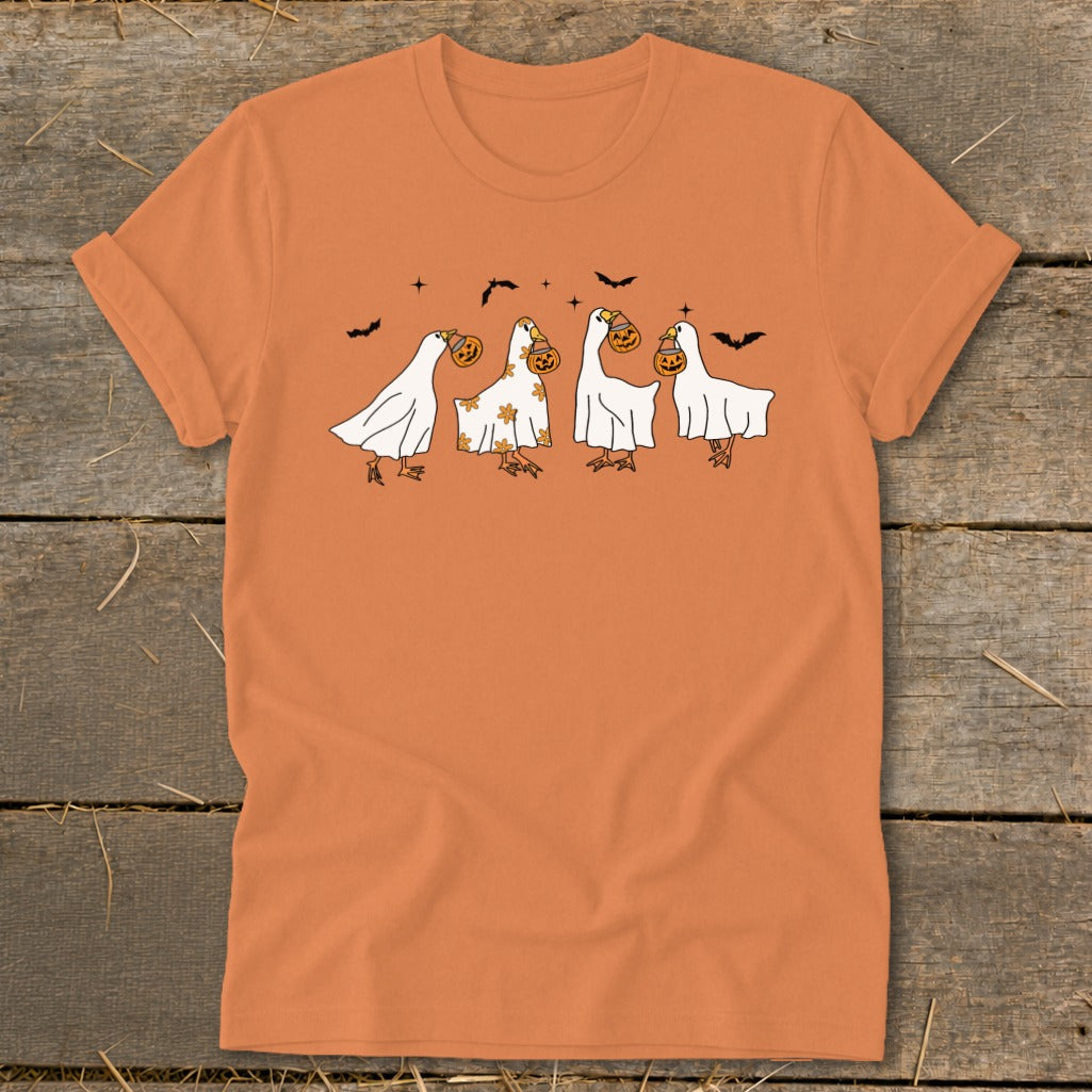Four cartoon geese dressed as ghosts, holding jack-o'-lanterns, with bats above.