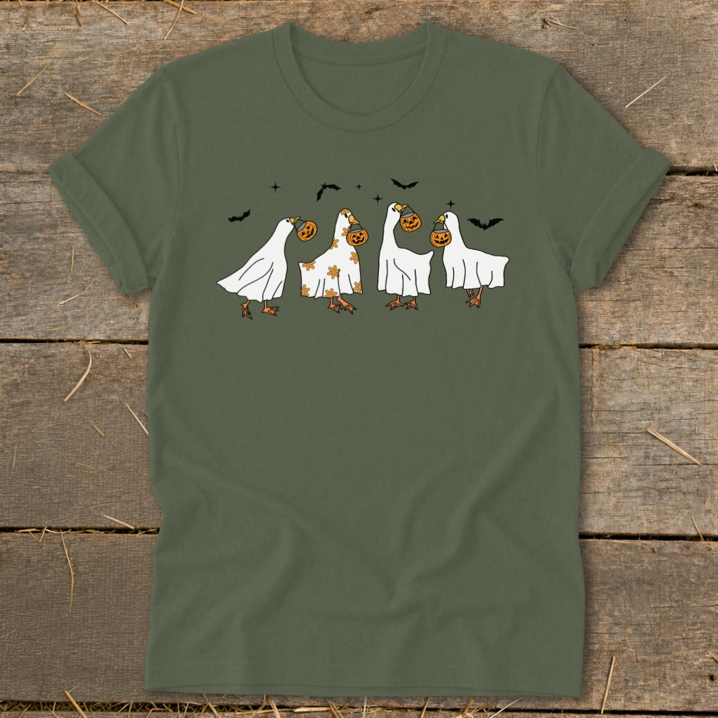 Four cartoon ducks in ghost costumes holding pumpkins with bats overhead.