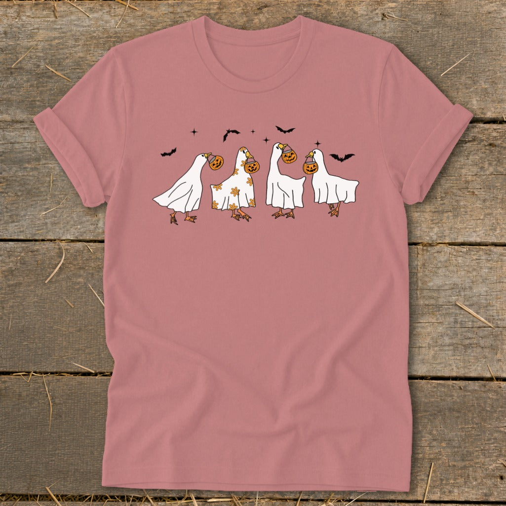 Four cartoon geese dressed as ghosts carry jack-o'-lanterns and bats fly above them.