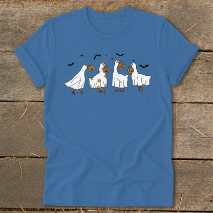Four geese in ghost costumes carrying pumpkins with bats in the background.