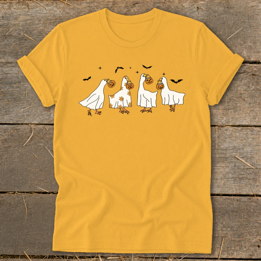 Yellow t-shirt with a Halloween graphic of geese dressed as ghosts carrying pumpkins.