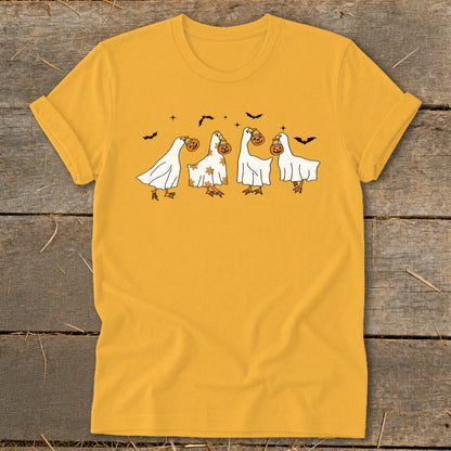 Yellow t-shirt with a Halloween graphic of geese dressed as ghosts carrying pumpkins.