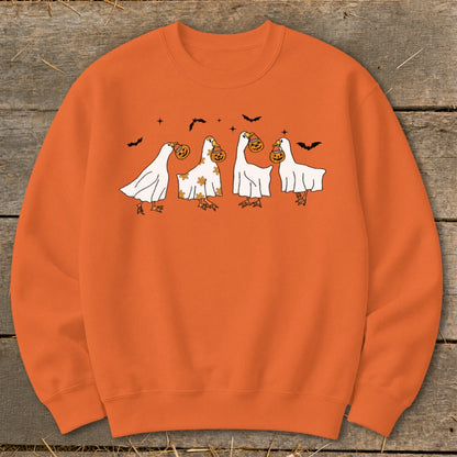 Orange sweatshirt with cartoon geese in ghost costumes holding pumpkins.