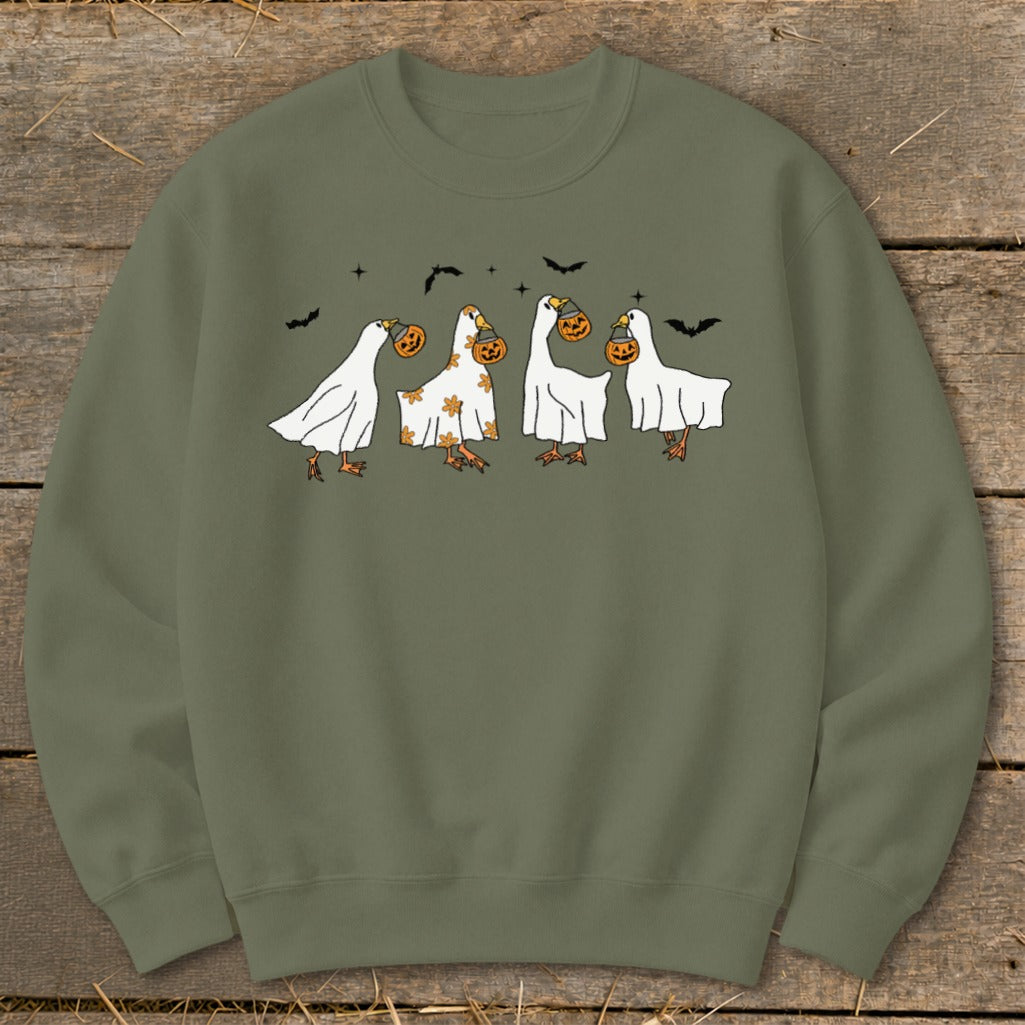 Olive green sweatshirt with four ducks dressed as ghosts carrying pumpkins.