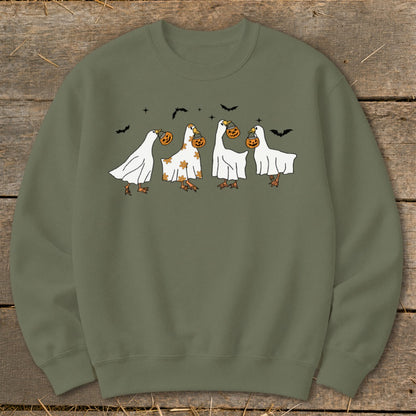 Olive green sweatshirt with four ducks dressed as ghosts carrying pumpkins.