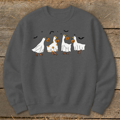 Four cartoon geese dressed as ghosts carrying pumpkins on a gray sweatshirt.