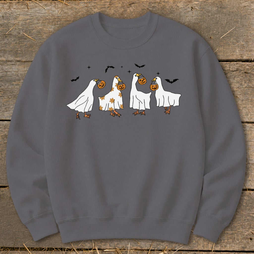 Four cartoon ghosts with pumpkins, flying bats, and stars on a gray sweatshirt.