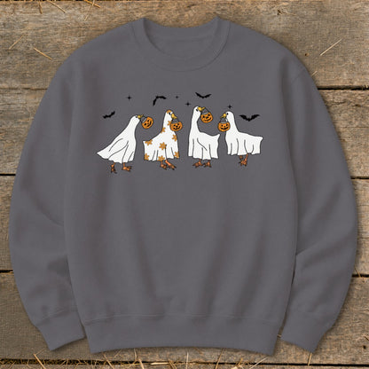 Four cartoon ghosts with pumpkins, flying bats, and stars on a gray sweatshirt.