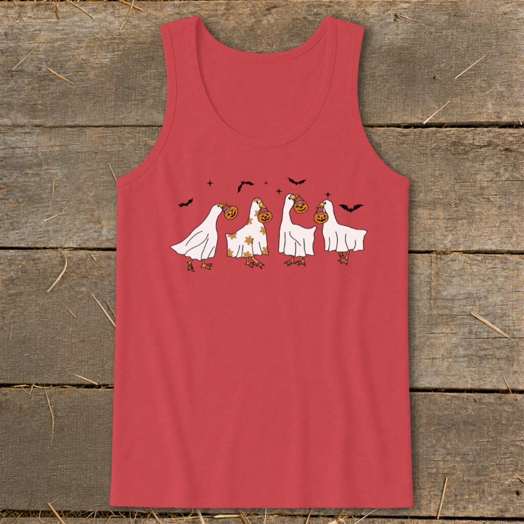 Four ducks dressed as ghosts with pumpkins and bats for Halloween.