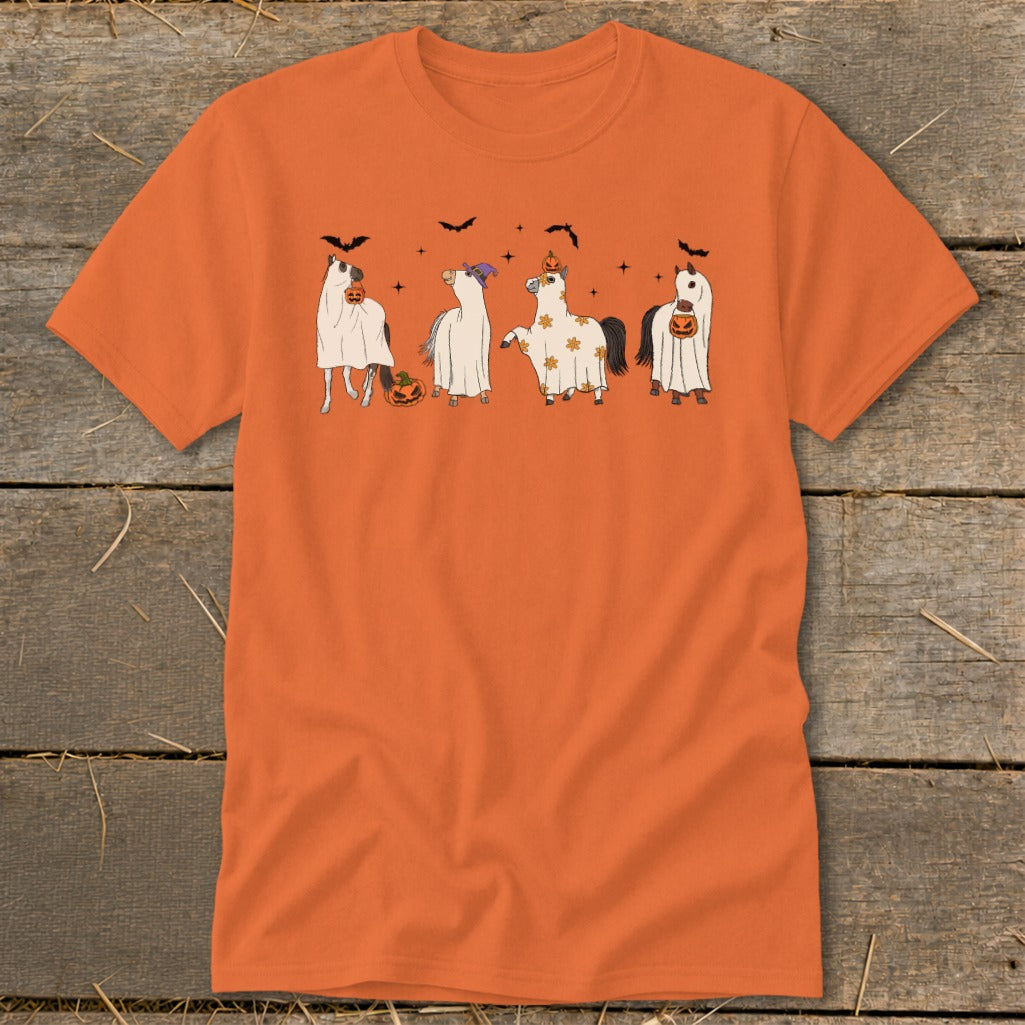 Four horses dressed in Halloween costumes including ghosts, pumpkins, and bats.