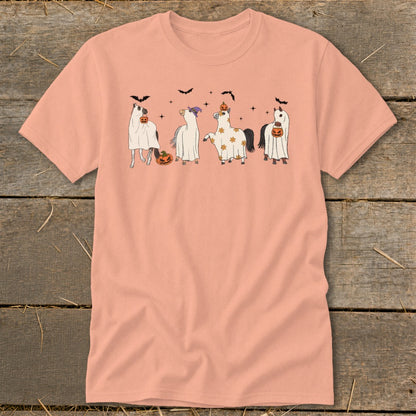 Four horses in ghost costumes with pumpkins and bats on a peach t-shirt.