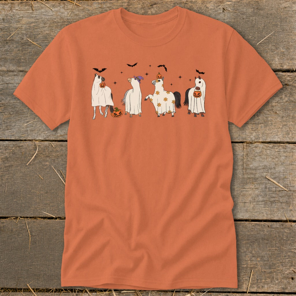 Four horses dressed as ghosts with pumpkins and bats for Halloween.