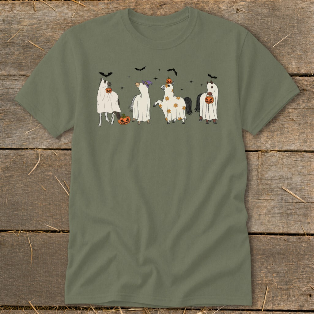 Four horses dressed in Halloween ghost costumes with pumpkins and bats.