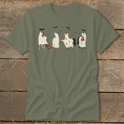 Four horses dressed in Halloween ghost costumes with pumpkins and bats.