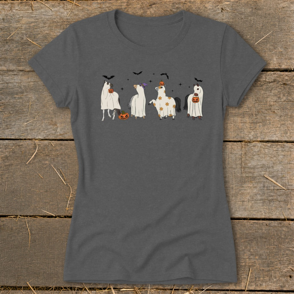 Four horses dressed as ghosts hold pumpkins, with bats in the background.