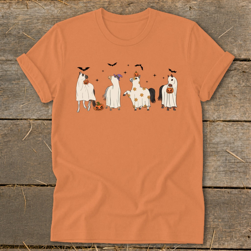 Four horses dressed in ghost costumes with pumpkins and bats for Halloween.