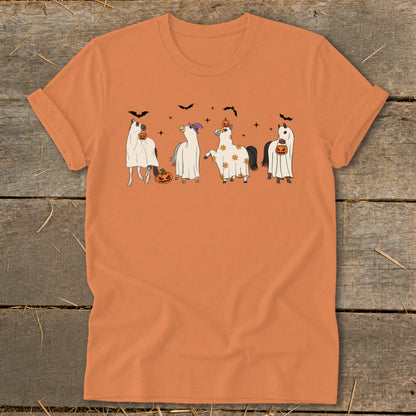 Four horses dressed in ghost costumes with pumpkins and bats for Halloween.