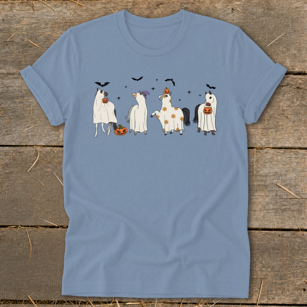 Four horses dressed in ghost costumes with pumpkins and bats for Halloween.