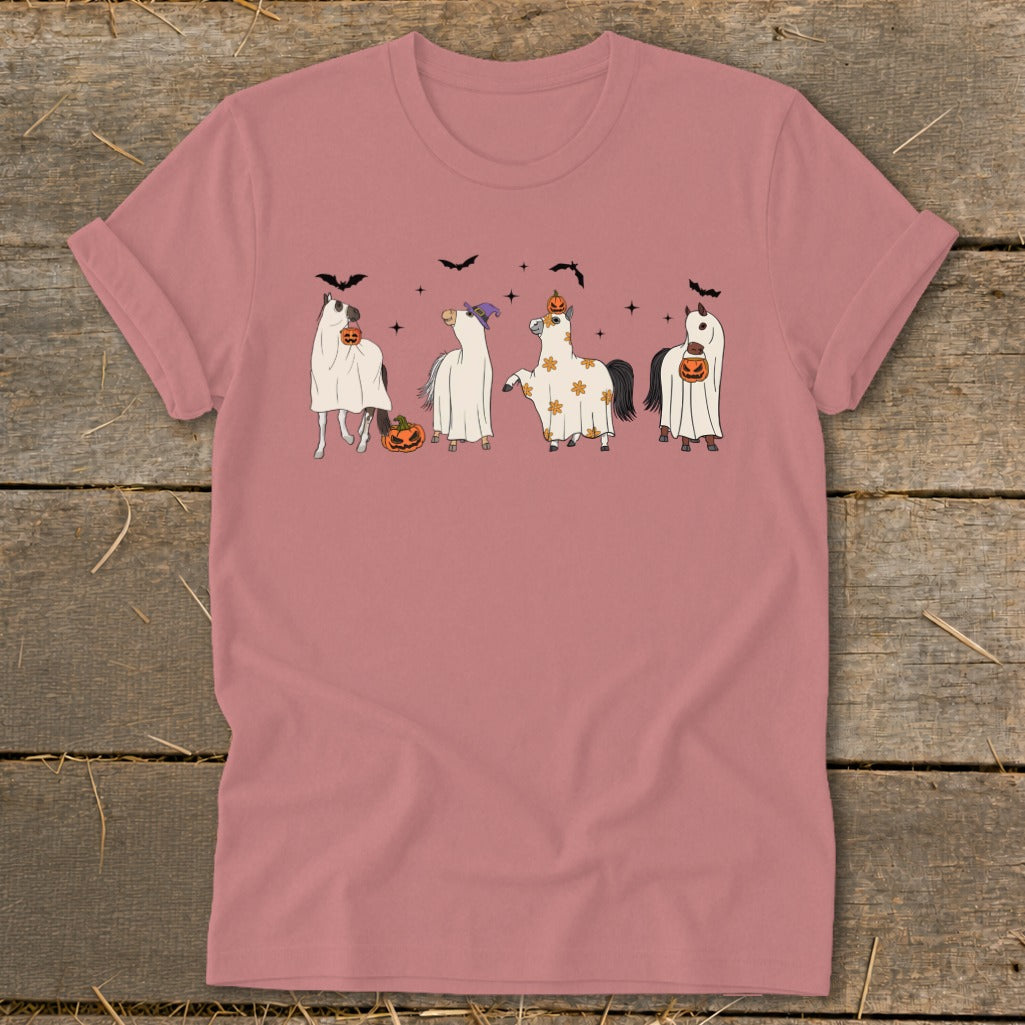 Four horses in ghost costumes with pumpkins and bats on a pink t-shirt.