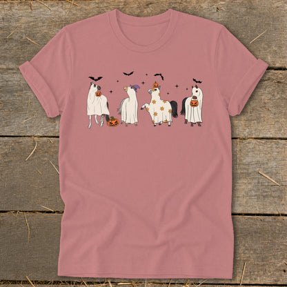 Four horses in ghost costumes with pumpkins and bats on a pink t-shirt.