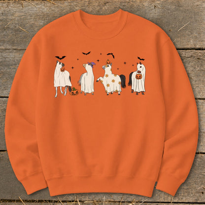 Four horses in ghost costumes with pumpkins and bats on an orange sweatshirt.