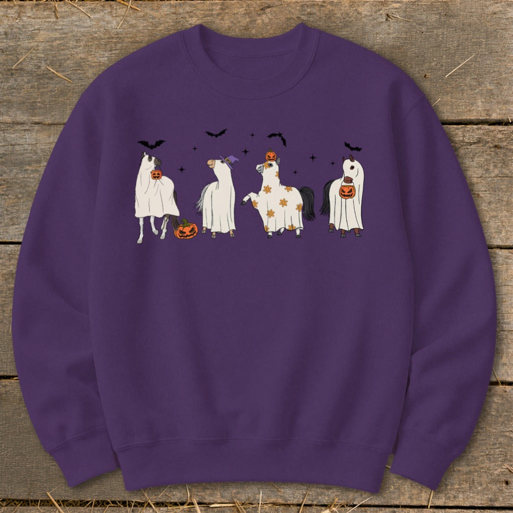 Four horses in ghost costumes with pumpkins, bats, and stars.