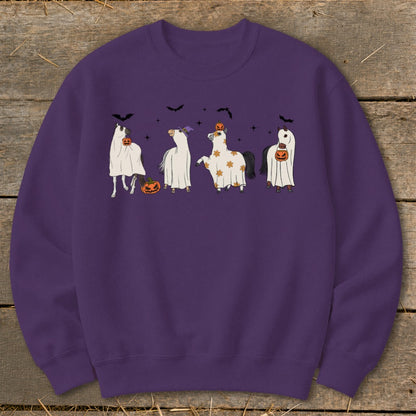 Four horses in ghost costumes with pumpkins, bats, and stars.