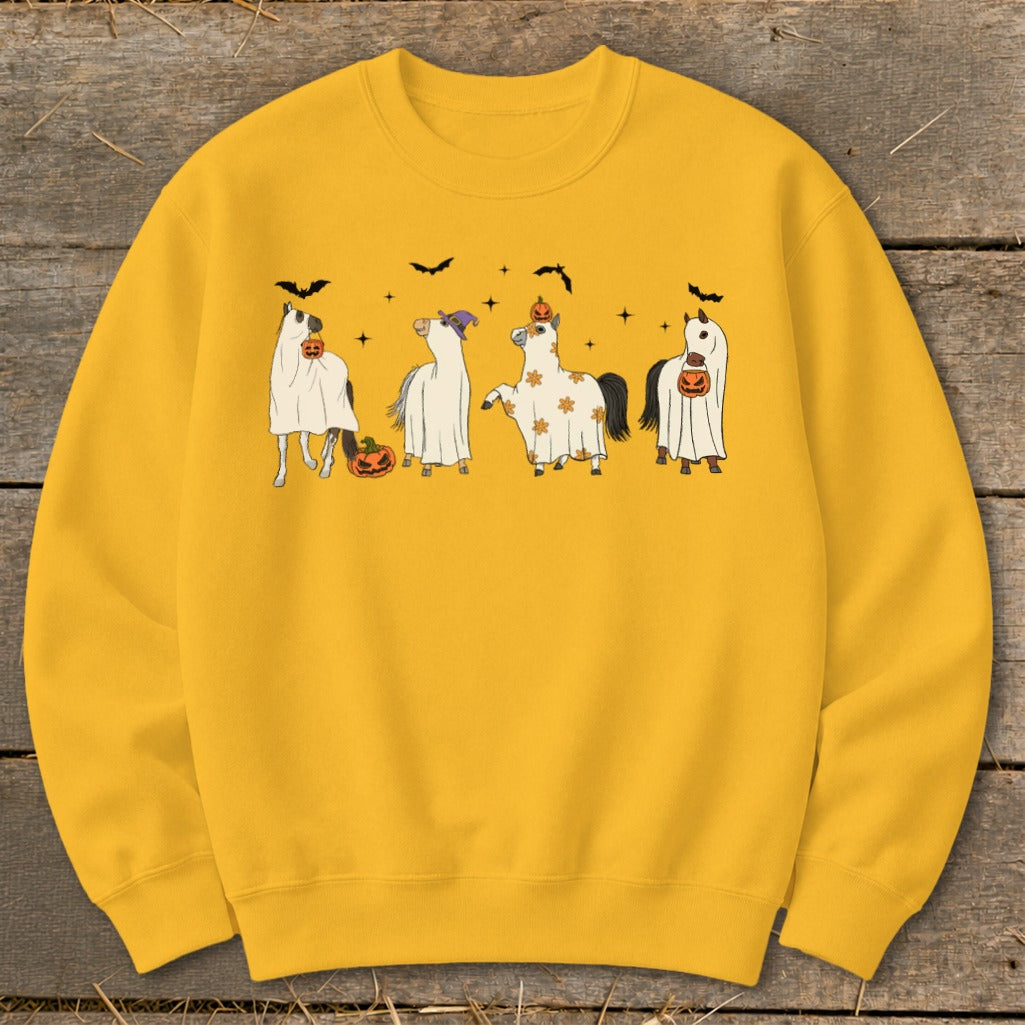 Four horses dressed as ghosts with pumpkins and bats around them.