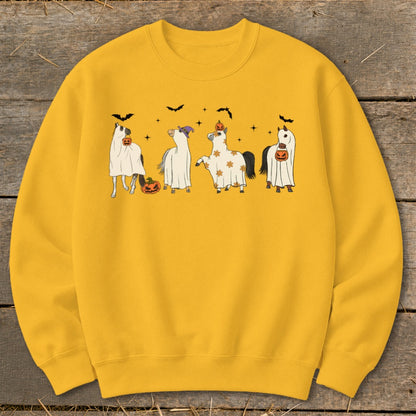 Four horses dressed as ghosts with pumpkins and bats around them.