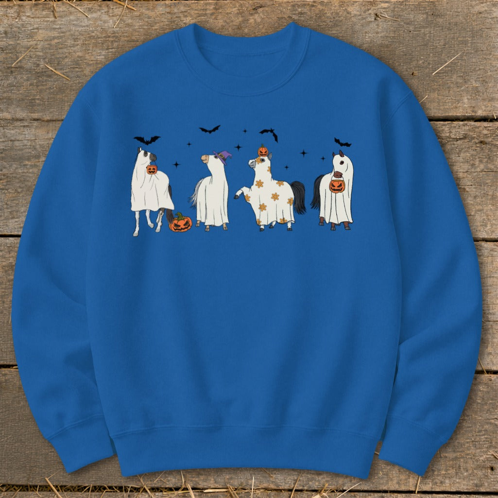Four horses in Halloween costumes with pumpkins and bats on a blue sweatshirt.