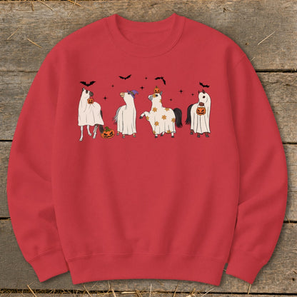 Four horses in ghost costumes with pumpkins and bats, on a red sweatshirt.