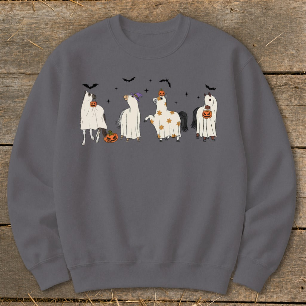 Four cartoon horses dressed in ghost costumes with pumpkins and bats for Halloween.