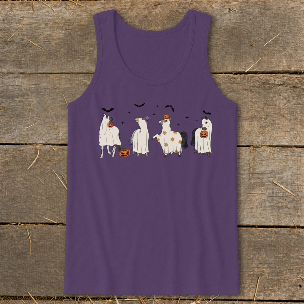 Four horses in Halloween ghost costumes with pumpkins and bats.