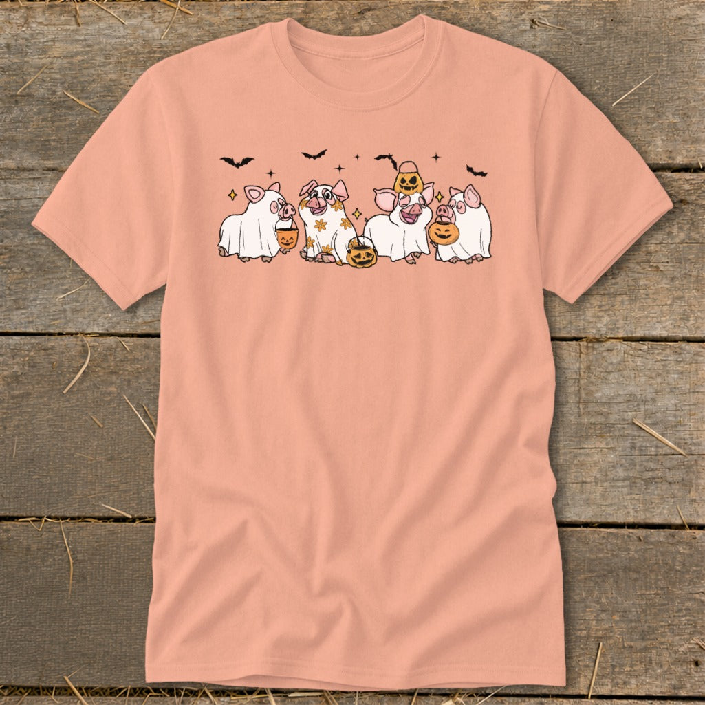 Five pigs dressed as ghosts hold pumpkins, with bats above.