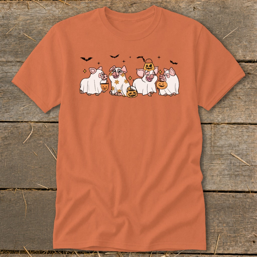 Orange t-shirt with five pigs dressed as ghosts holding pumpkins and bats above.