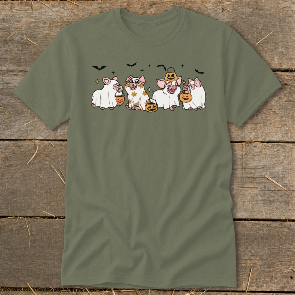 Four pigs in ghost costumes holding pumpkins with bats in the background.