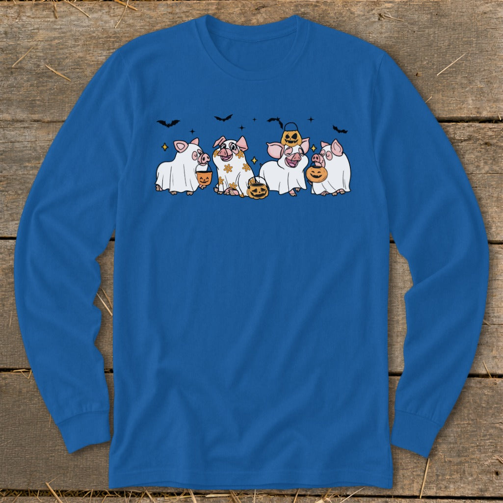 Four pigs in ghost costumes with pumpkins and bats on a blue long-sleeve shirt.