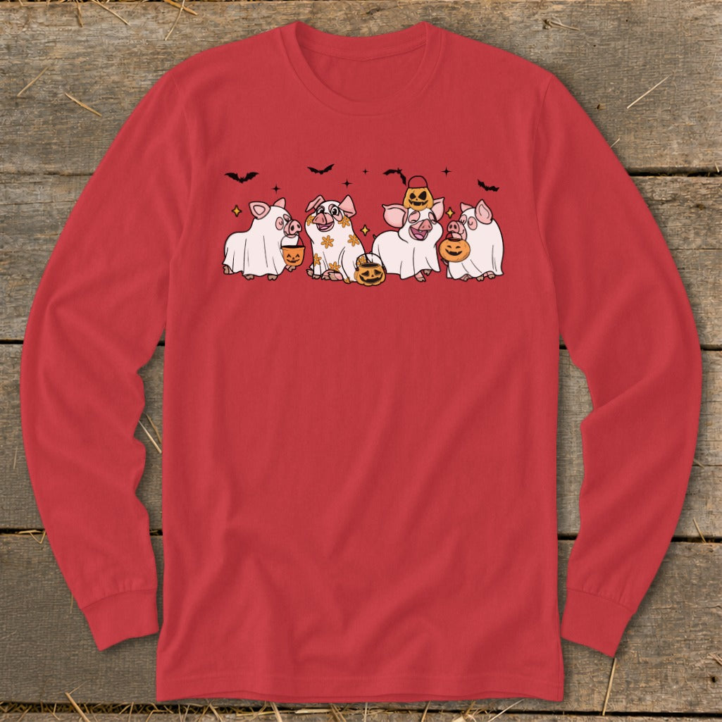 Red long-sleeve shirt featuring four pigs in ghost costumes with pumpkins and bats.